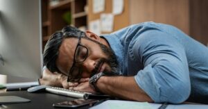 Man with methylation issues sleeping on his desk.