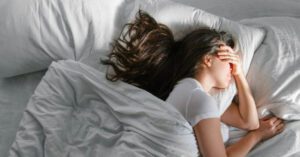 woman having trouble sleeping in bed