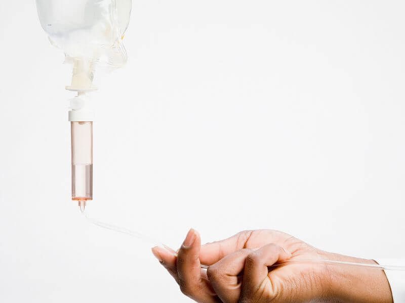 Woman's hand holding IV Therapy Bad