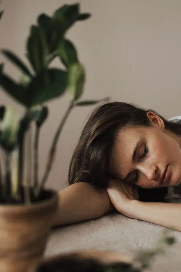 A woman with autoimmune disease sleeps on a table.