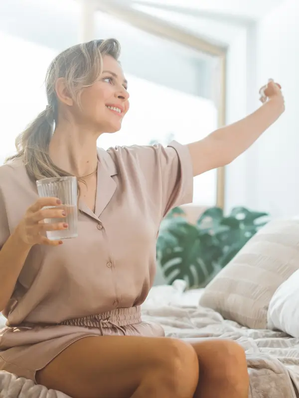 Woman sitting on bed feeling great from bio-identical hormone therapy