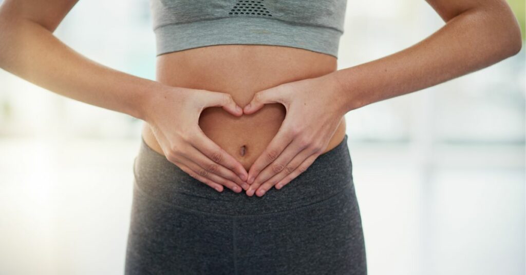 Woman pointing to her gut microbiome while on ozempic 