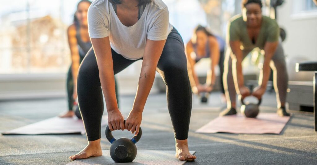 Woman doing weight resistance exercise while on Ozempic