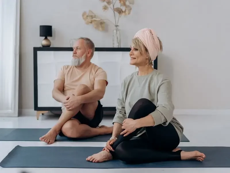 Hormone-Imbalance Mature couple doing yoga after feeling invigorated from bio-identical hormone therapy