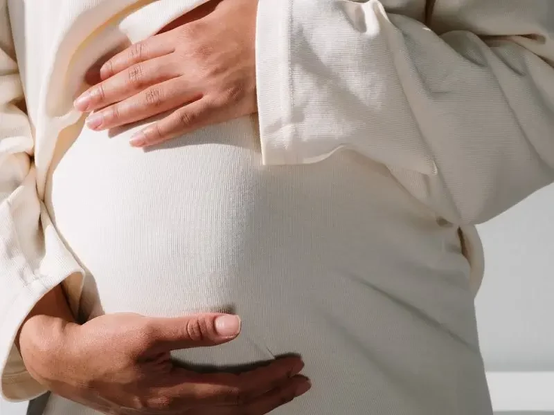 Infertility-Womens-health-600×800 A pregnant woman holding her belly.